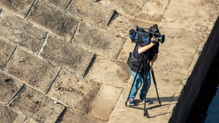 A cameraman filming one of the productions that have decided to resume.